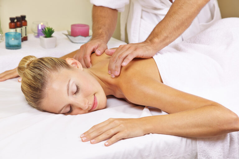 Woman receiving a nape massage in day spa from a masseur